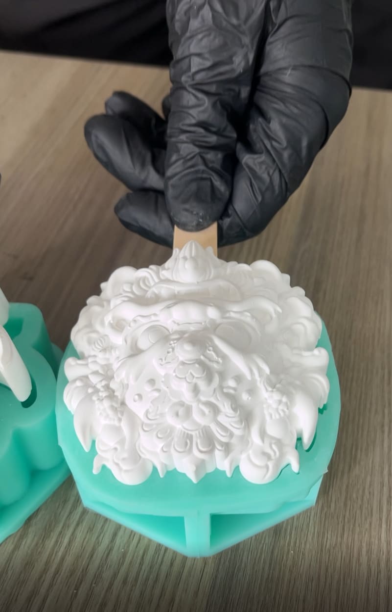Food-grade silicone mold demold of detailed lion popsicle with gloved hand